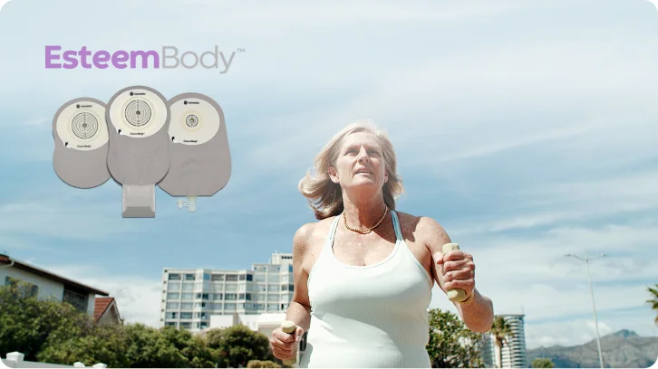 Un'immagine che presenta Esteem Body™ come un nuovo sistema di stomia convessa morbida in un unico pezzo con Leak Defense™, con una donna che tiene in mano manubri mentre fa jogging sullo sfondo dell'immagine.